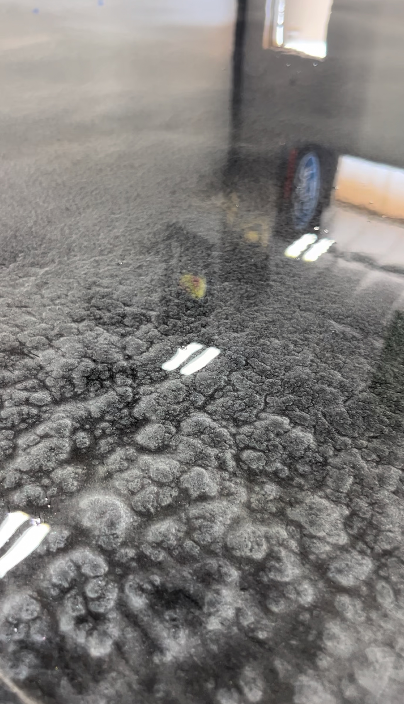 Close-up of a glossy charcoal Rezena Metallic floor pattern