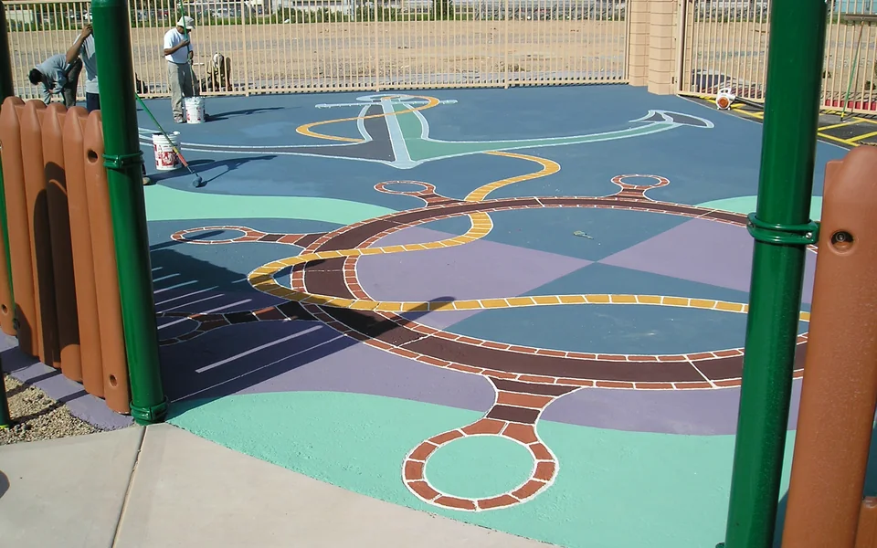 Decorative colored asphalt surface during installation; an Asphatec family example, not a confirmed AsphaCoat installation